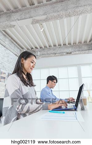 Stock Photo - Japanese people working in modern office. Fotosearch