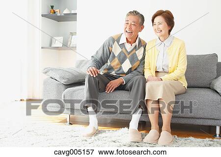 Stock Photo - Japanese senior couple on the sofa. Fotosearch