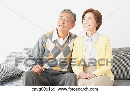 Stock Photography - Japanese senior couple on the sofa. Fotosearch