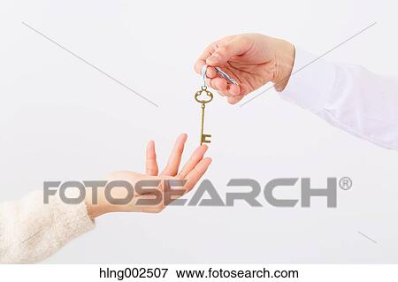Man and woman hands passing key View Large Photo Image Stock Photo - Man and woman hands passing key. Fotosearch