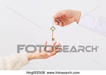 Man and woman hands passing key View Large Photo Image Stock Photo - Man and woman hands passing key. Fotosearch