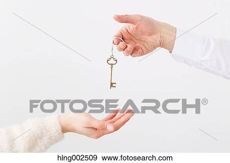 Man and woman hands passing key View Large Photo Image Stock Photo - Man and woman hands passing key. Fotosearch