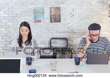 Multi-ethnic business people working in modern office View Large Photo Image Picture - Multi-ethnic business people working in modern office. Fotosearch