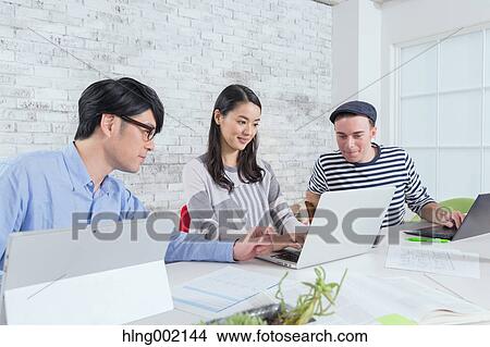 Multi-ethnic business people working in modern office View Large Photo Image Picture - Multi-ethnic business people working in modern office. Fotosearch