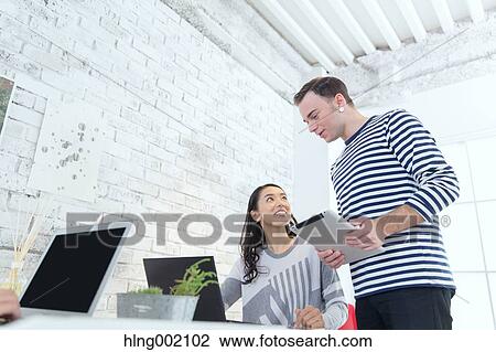 Stock Image - Multi-ethnic business people working in modern office. Fotosearch