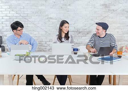 Multi-ethnic business people working in modern office View Large Photo Image Stock Image - Multi-ethnic business people working in modern office. Fotosearch