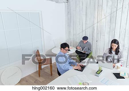 Multi-ethnic business people working in modern office View Large Photo Image Stock Image - Multi-ethnic business people working in modern office. Fotosearch