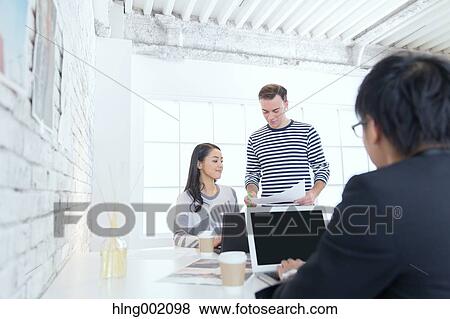Multi-ethnic business people working in modern office View Large Photo Image Stock Photo - Multi-ethnic business people working in modern office. Fotosearch