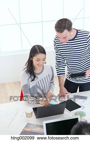Multi-ethnic business people working in modern office View Large Photo Image Stock Photo - Multi-ethnic business people working in modern office. Fotosearch