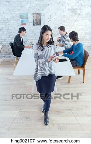 Multi-ethnic business people working in modern office View Large Photo Image Stock Photo - Multi-ethnic business people working in modern office. Fotosearch