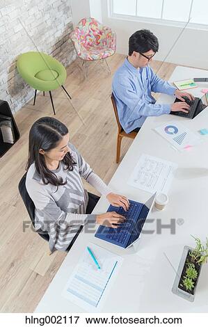 Multi-ethnic business people working in modern office View Large Photo Image Stock Photo - Multi-ethnic business people working in modern office. Fotosearch