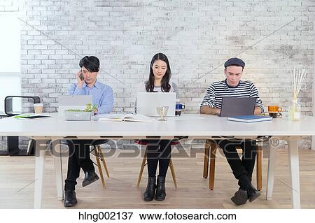 Multi-ethnic business people working in modern office View Large Photo Image Stock Photo - Multi-ethnic business people working in modern office. Fotosearch