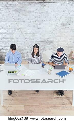 Multi-ethnic business people working in modern office View Large Photo Image Stock Photo - Multi-ethnic business people working in modern office. Fotosearch