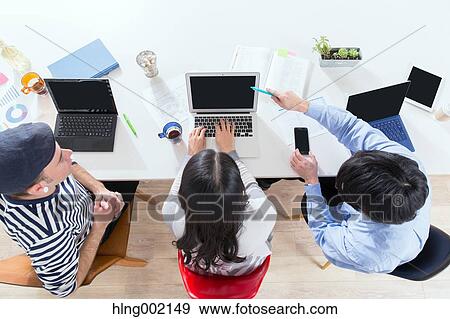 Multi-ethnic business people working in modern office View Large Photo Image Stock Photo - Multi-ethnic business people working in modern office. Fotosearch