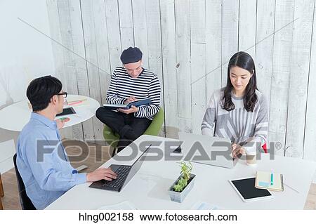 Multi-ethnic business people working in modern office View Large Photo Image Stock Photo - Multi-ethnic business people working in modern office. Fotosearch