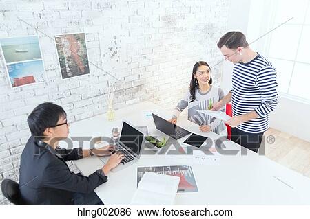 Multi-ethnic business people working in modern office View Large Photo Image Stock Photograph - Multi-ethnic business people working in modern office. Fotosearch