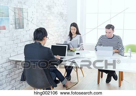 Multi-ethnic business people working in modern office View Large Photo Image Stock Photograph - Multi-ethnic business people working in modern office. Fotosearch