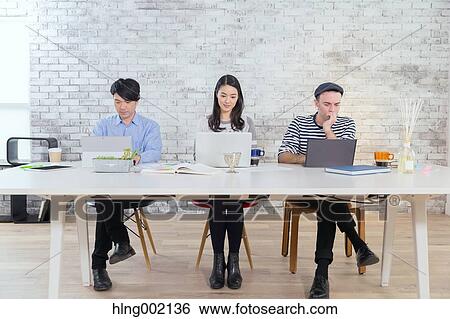 Multi-ethnic business people working in modern office View Large Photo Image Stock Photograph - Multi-ethnic business people working in modern office. Fotosearch