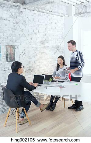 Multi-ethnic business people working in modern office View Large Photo Image Stock Photography - Multi-ethnic business people working in modern office. Fotosearch