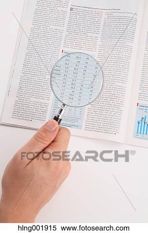 Stock Photography - Newspaper and magnifying glass. Fotosearch