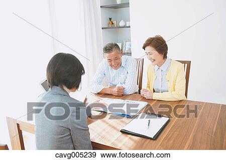Senior Japanese couple consulting with financial planner View Large Photo Image Stock Photo - Senior Japanese couple consulting with financial planner. Fotosearch
