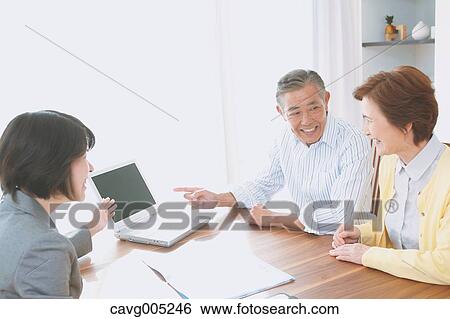 Senior Japanese couple consulting with financial planner View Large Photo Image Stock Photograph - Senior Japanese couple consulting with financial planner. Fotosearch