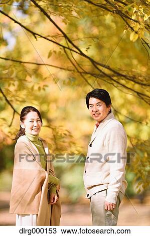 Senior Japanese couple in a city park in Autumn View Large Photo Image Stock Image - Senior Japanese couple in a city park in Autumn. Fotosearch