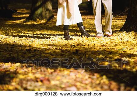 Stock Photo - Senior Japanese couple in a city park in Autumn. Fotosearch