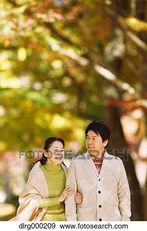 Senior Japanese couple in a city park in Autumn View Large Photo Image Stock Photo - Senior Japanese couple in a city park in Autumn. Fotosearch