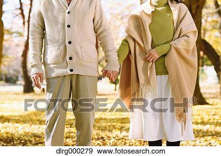 Senior Japanese couple in a city park in Autumn View Large Photo Image Stock Photo - Senior Japanese couple in a city park in Autumn. Fotosearch