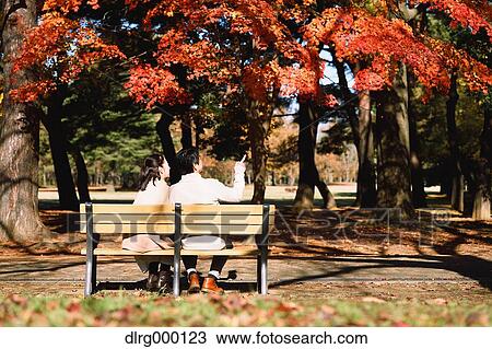Senior Japanese couple sitting on a bench in a city park View Large Photo Image Stock Image - Senior Japanese couple sitting on a bench in a city park. Fotosearch
