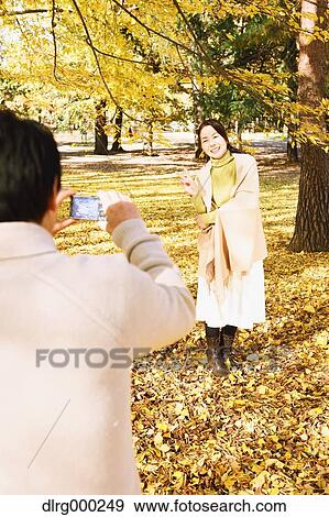 Senior Japanese couple taking pictures in a city park in Autumn View Large Photo Image Stock Photo - Senior Japanese couple taking pictures in a city park in Autumn. Fotosearch