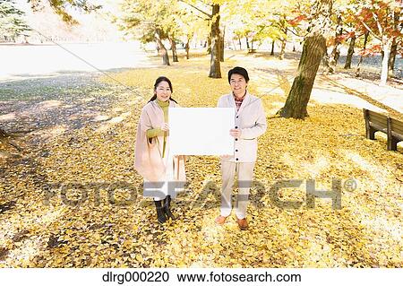 Senior Japanese couple with whiteboard in a city park View Large Photo Image Stock Image - Senior Japanese couple with whiteboard in a city park. Fotosearch