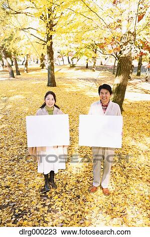 Senior Japanese couple with whiteboard in a city park View Large Photo Image Stock Image - Senior Japanese couple with whiteboard in a city park. Fotosearch