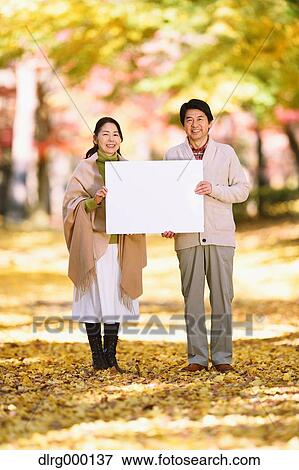 Senior Japanese couple with whiteboard in a city park View Large Photo Image Stock Photo - Senior Japanese couple with whiteboard in a city park. Fotosearch
