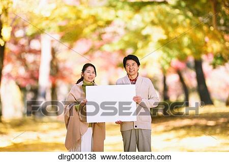 Senior Japanese couple with whiteboard in a city park View Large Photo Image Stock Photo - Senior Japanese couple with whiteboard in a city park. Fotosearch