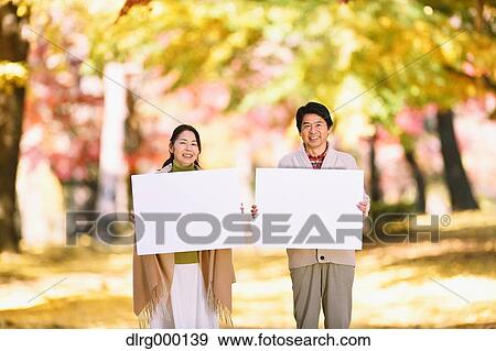 Senior Japanese couple with whiteboard in a city park View Large Photo Image Stock Photo - Senior Japanese couple with whiteboard in a city park. Fotosearch
