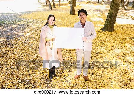 Senior Japanese couple with whiteboard in a city park View Large Photo Image Stock Photo - Senior Japanese couple with whiteboard in a city park. Fotosearch
