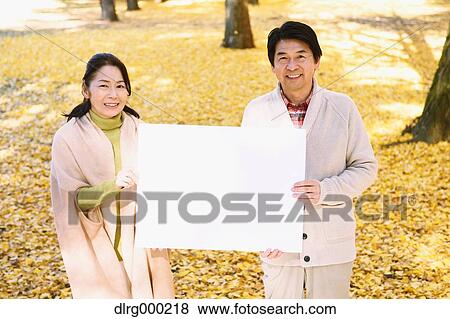 Senior Japanese couple with whiteboard in a city park View Large Photo Image Stock Photo - Senior Japanese couple with whiteboard in a city park. Fotosearch