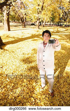 Senior Japanese man taking a selfie in a city park in Autumn View Large Photo Image Stock Photograph - Senior Japanese man taking a selfie in a city park in Autumn. Fotosearch