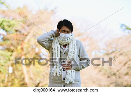 Senior Japanese man with mask feeling sick View Large Photo Image Picture - Senior Japanese man with mask feeling sick. Fotosearch