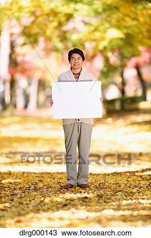 Senior Japanese man with whiteboard in a city park in Autumn View Large Photo Image Stock Image - Senior Japanese man with whiteboard in a city park in Autumn. Fotosearch