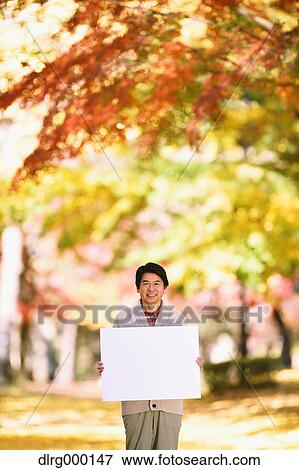 Senior Japanese man with whiteboard in a city park in Autumn View Large Photo Image Stock Photo - Senior Japanese man with whiteboard in a city park in Autumn. Fotosearch