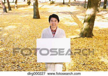 Senior Japanese man with whiteboard in a city park in Autumn View Large Photo Image Stock Photo - Senior Japanese man with whiteboard in a city park in Autumn. Fotosearch