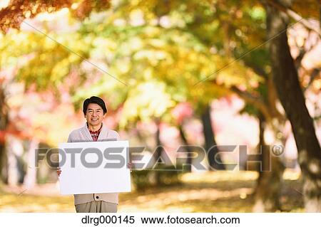 Senior Japanese man with whiteboard in a city park in Autumn View Large Photo Image Stock Photography - Senior Japanese man with whiteboard in a city park in Autumn. Fotosearch