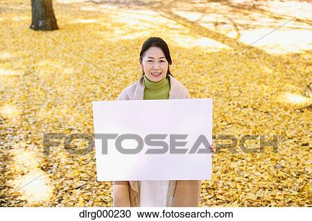 Senior Japanese woman with whiteboard in a city park in Autumn View Large Photo Image Stock Image - Senior Japanese woman with whiteboard in a city park in Autumn. Fotosearch