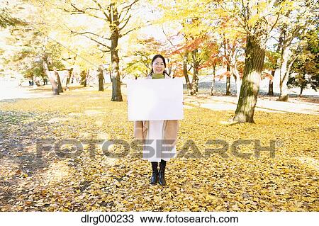 Senior Japanese woman with whiteboard in a city park in Autumn View Large Photo Image Stock Image - Senior Japanese woman with whiteboard in a city park in Autumn. Fotosearch