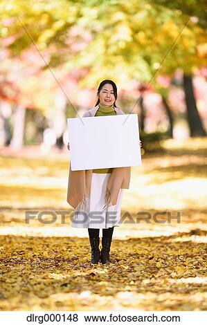Senior Japanese woman with whiteboard in a city park in Autumn View Large Photo Image Stock Photo - Senior Japanese woman with whiteboard in a city park in Autumn. Fotosearch