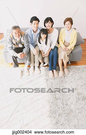 Three-generation Japanese family on the sofa in the living room View Large Photo Image Picture - Three-generation Japanese family on the sofa in the living room. Fotosearch