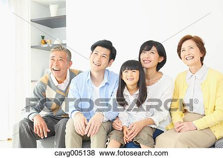 Stock Photo - Three-generation Japanese family on the sofa in the living room. Fotosearch